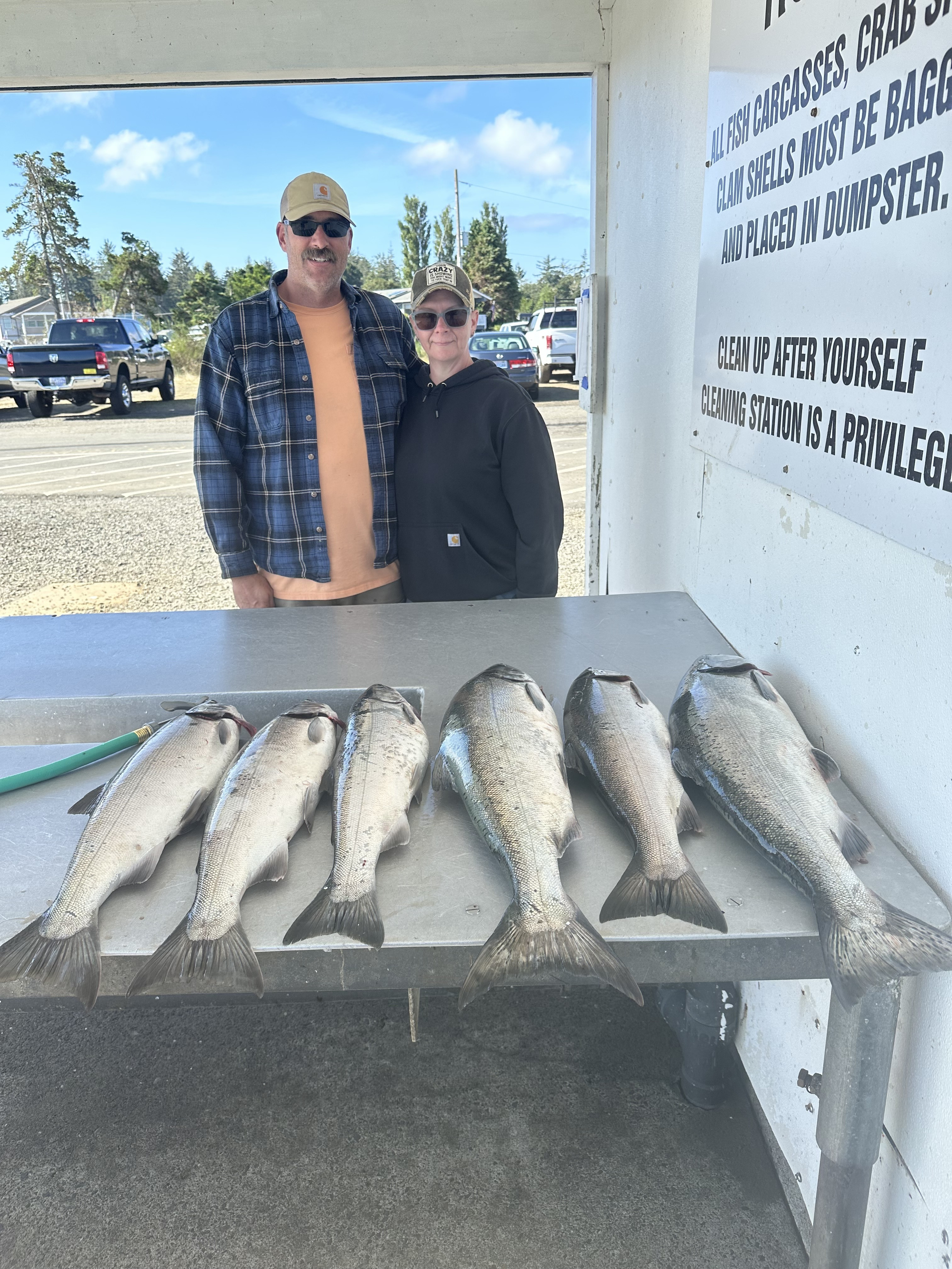 Guests with salmon at the South Channel fish cleaning station
