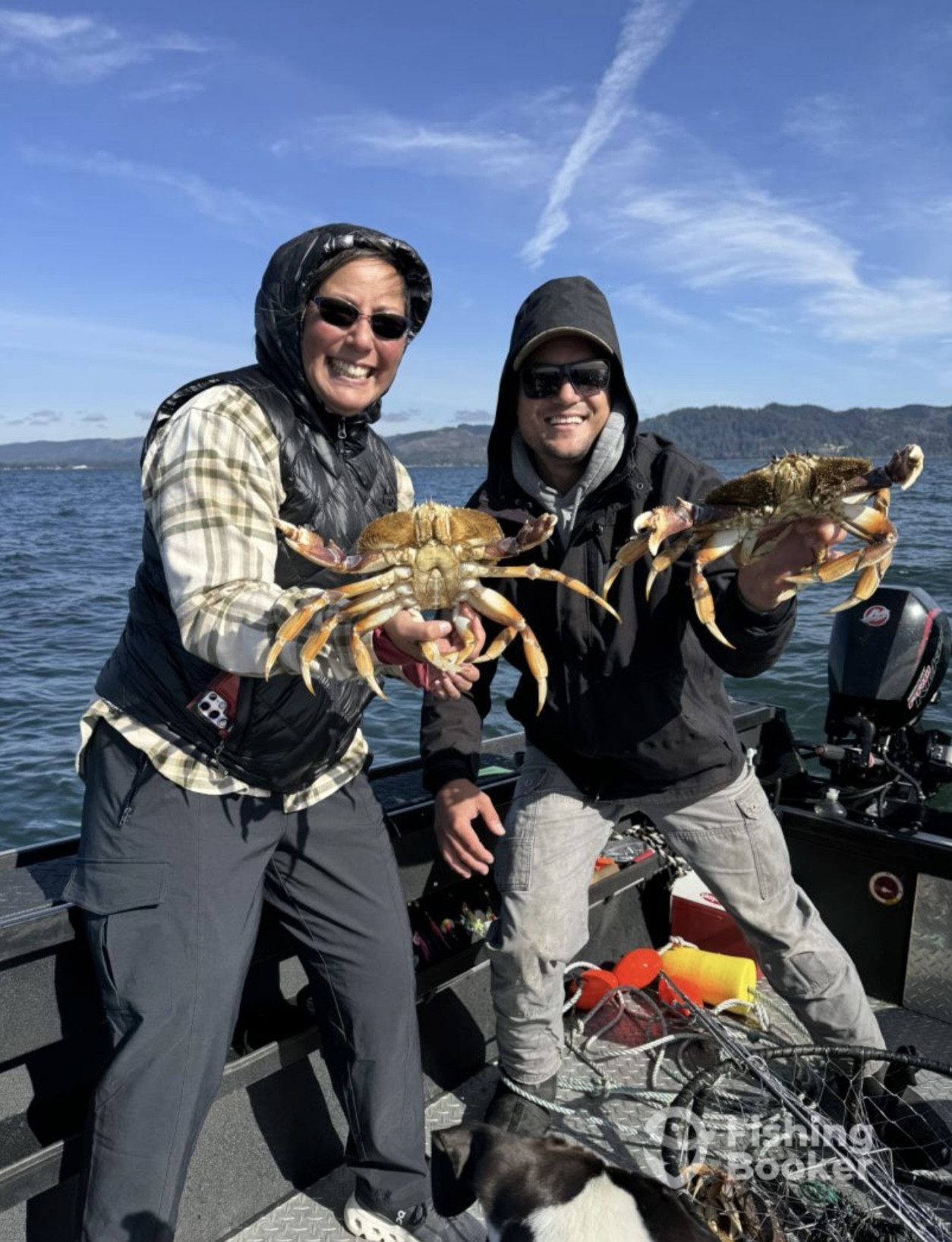 Guests holding Dungeness crab during a guided crabbing trip